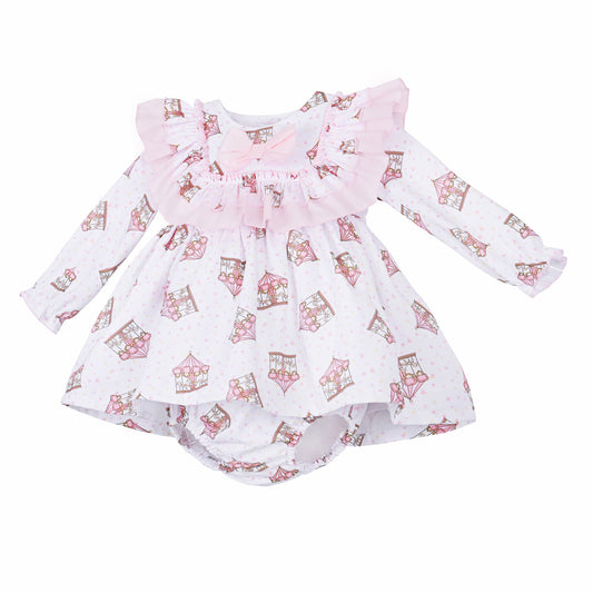 Angled view of the pink carousel dress showing long sleeves and matching printed pants