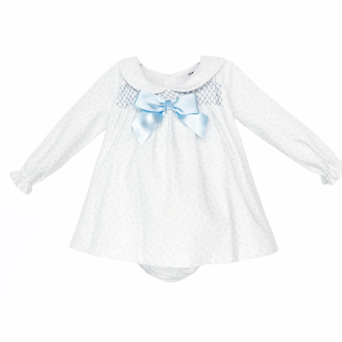 White baby girls dress and matching pants with pale blue hearts, smocking and a blue bow