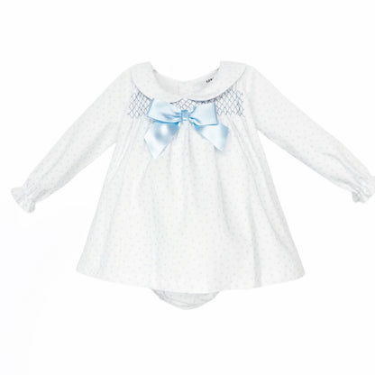 White baby girls dress and matching pants with pale blue hearts, smocking and a blue bow