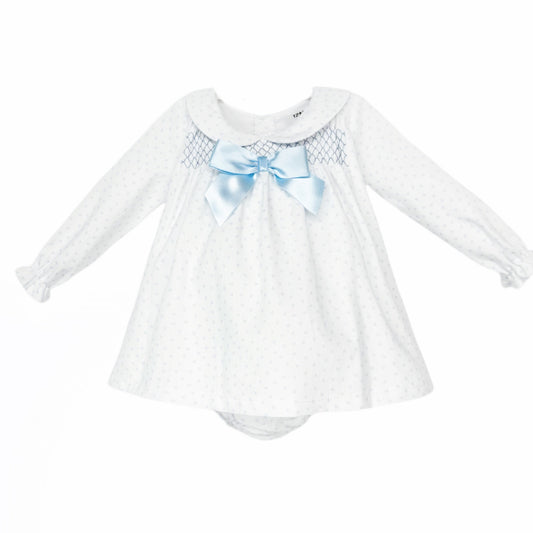 White baby girls dress and matching pants with pale blue hearts, smocking and a blue bow