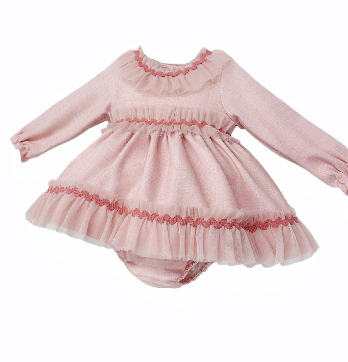 Angled view of the pink dress and pants set showing sheer neckline, waist and hem frills