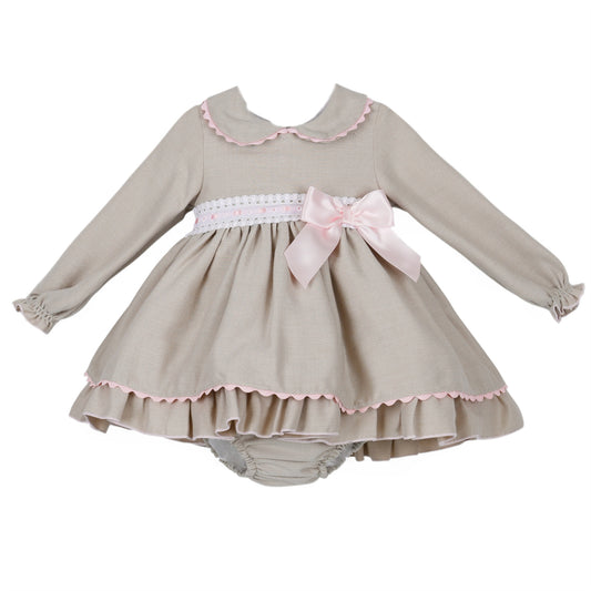 Grey textured baby dress and pants with pale pink bow, rounded collar and white waist trim