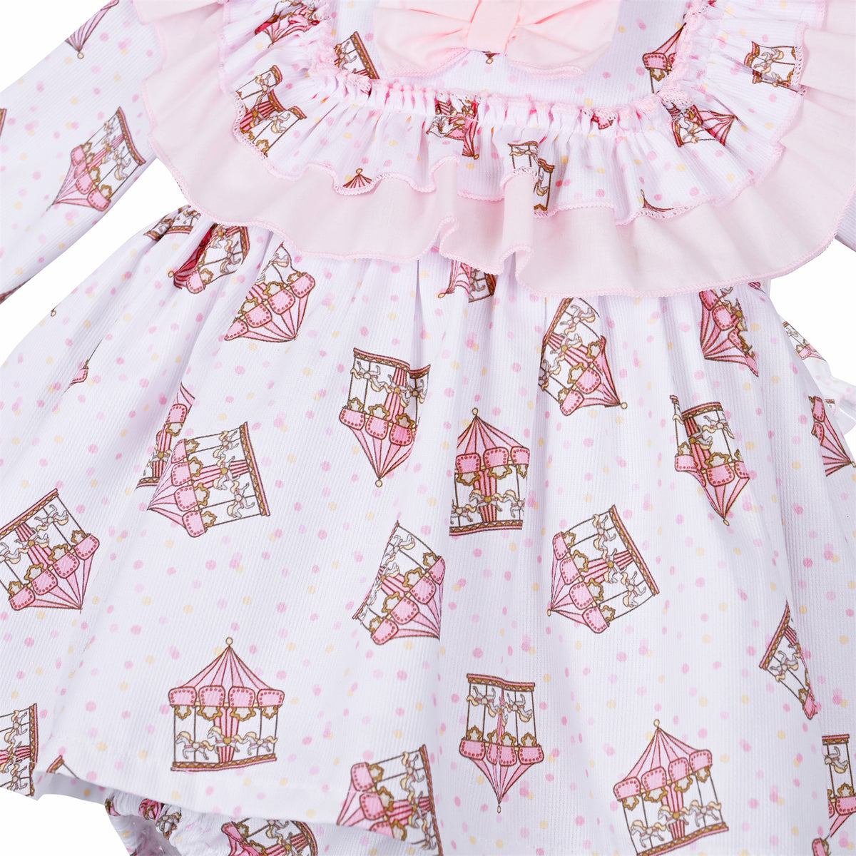 Close-up of miniature carousel print, pink dots and the double frill on the dress