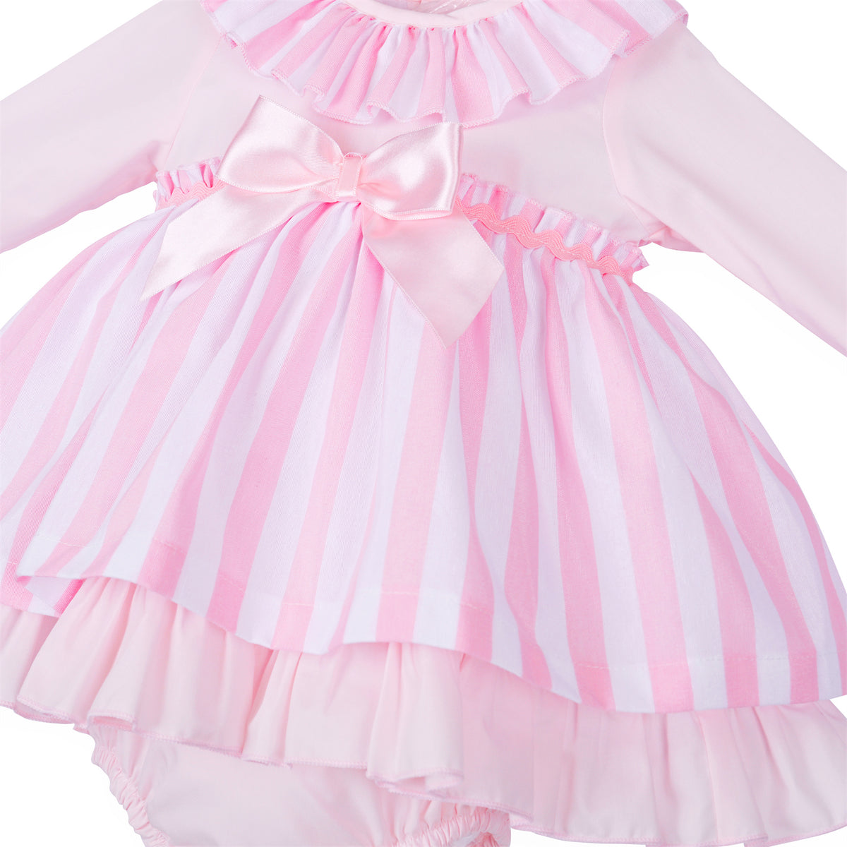 Close-up of pink and white stripes, glossy waist bow and wavy pink trim
