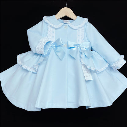 Pale blue jacket on a hanger showing the front buttons and ribbon trim