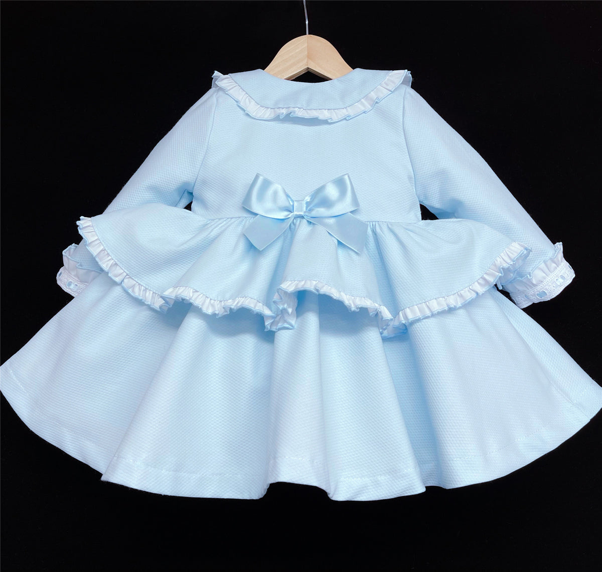 Rear view of the blue bow jacket with its flared lower section