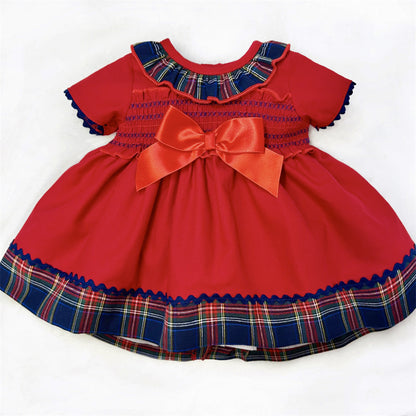 Red baby dress and matching pants with a smocked chest, large bow and tartan trim